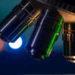 Science Shocker: New Discoveries Hint at Divine Design Closeup of microscope lenses with colorful background