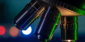 Closeup of microscope lenses with colorful background