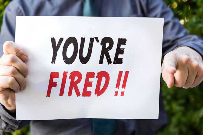 388134190 Person holding YOURE FIRED sign