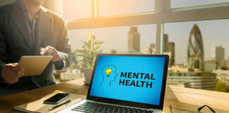 Laptop displaying Mental Health screen in an office