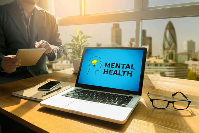Laptop displaying Mental Health screen in an office