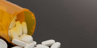 Spilled prescription bottle with white pills
