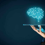 Hand holding tablet projecting digital brain hologram