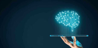 Hand holding tablet projecting digital brain hologram