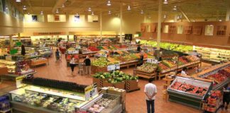 Interior of a grocery store filled with fresh produce and shoppers
