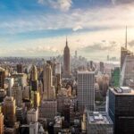 Aerial view of New York City skyline featuring the Empire State Building at sunset