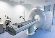 Crystal Camera SHOCKS Doctors—Cancer Hunted Early A CT scanner in a hospital room with medical equipment nearby