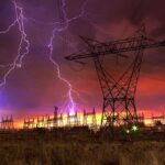 Meteorologist’s Safety Tip: Don’t Do This During Storms Lightning strikes illuminate a power station against a colorful sunset sky