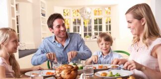 A family enjoying a dinner together at a table filled with food