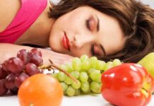 Astounding Sleep Discovery—Experts Stunned by Results A woman resting her head on a table surrounded by various fruits