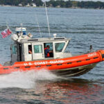Coast Guard boat speeding on the water