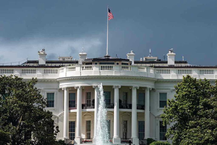 White House with American flag and fountain stormy sky