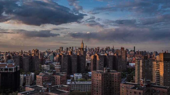 shutterstock_122429365.jpg A panoramic view of New York City skyline during sunset with clouds