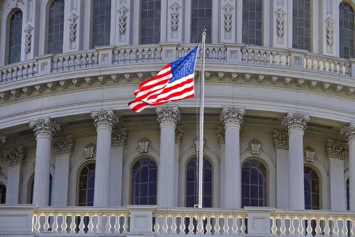 shutterstock_90512380.jpg American flag waving in front of the Capitol building