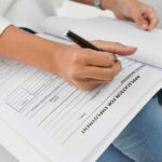 Person filling out job application form