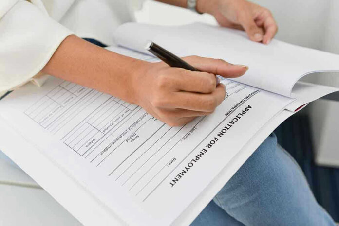 Person filling out job application form