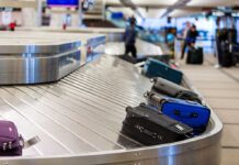 Luggage on a conveyor belt at an airport baggage claim area