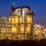 An industrial facility with illuminated structures at night