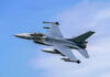 Fighter Jet Mystery: New Missile Spotted Jet fighter flying through clear blue sky.