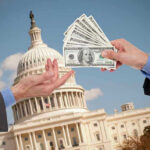 Hands exchanging money in front of Capitol building.