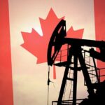 Silhouette of an oil rig against the Canadian flag