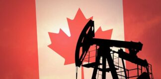 Silhouette of an oil rig against the Canadian flag