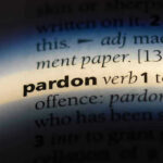 The word pardon highlighted in a dictionary.