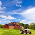 Murder-for-Hire Plot: Body Fed to HOGS A vintage tractor in front of a red barn on a sunny day