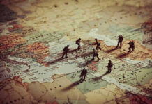 Toy soldiers on a world map background.