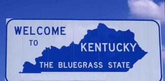 Welcome sign for Kentucky, the Bluegrass State, with a blue background