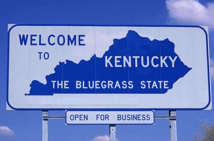 shutterstock_102527837.jpg Welcome sign for Kentucky, the Bluegrass State, with a blue background