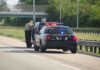 Police officer conducting a traffic stop on a highway