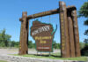 Wisconsin welcome sign with industry, agriculture, and recreation.