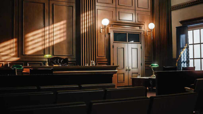Empty courtroom with judges bench and wooden decor.