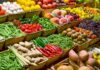 A vibrant display of assorted fruits and vegetables in baskets at a market
