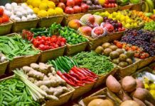 A vibrant display of assorted fruits and vegetables in baskets at a market