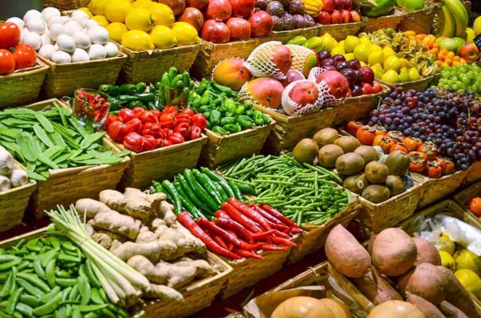 A vibrant display of assorted fruits and vegetables in baskets at a market