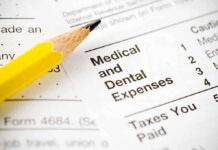 Close-up of tax document with medical and dental expenses section and a yellow pencil