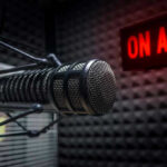 Chinese Cash FUELS U.S. Politics – Shocking Links Microphone in soundproof studio with On Air sign.