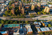 Aerial view of urban area with tall buildings and freeway.
