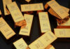 Gold bars stacked on dark background