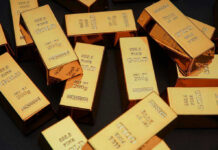 Gold bars stacked on dark background
