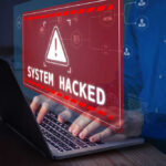 Ivanka Trump: Target of Iran-Backed Assassin? Warning sign System Hacked on laptop screen.