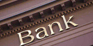 Bank sign on building facade.