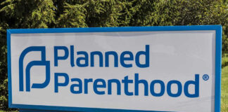 Planned Parenthood sign on a grassy lawn.