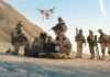 Russian Drone Hits Romania: NATO on Edge Soldiers operating a drone in a desert environment.