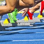Transgender Athlete’s Win Sparks Federal Showdown Athletes starting a sprint from starting blocks on a blue track