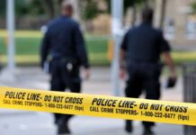 Seattle Streets Turn BATTLE ZONE – Kids at Risk Police officers walking past caution tape at a crime scene