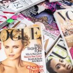 A collection of Vogue magazines featuring various covers and celebrity portraits
