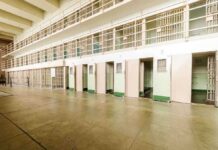 SHOCKING Suicides Surge in ICE Detention Interior view of a prison cell block with empty cells and security bars